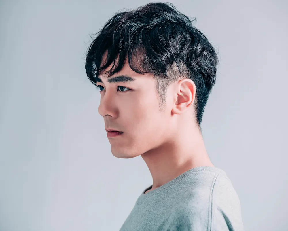 Short textured men’s haircut with tapered sides