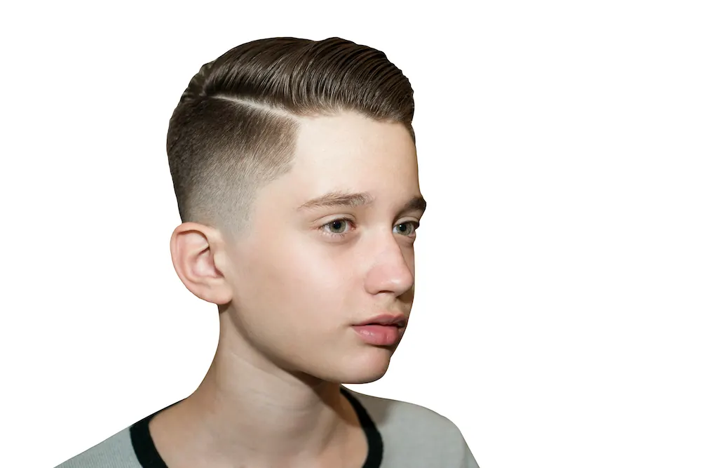 Boy’s side-part haircut with a fade
